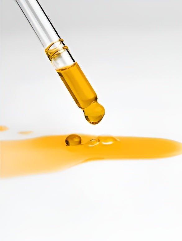 Eclat Soin Organic Nourishing Facial Oil dropper with golden oil on a white background